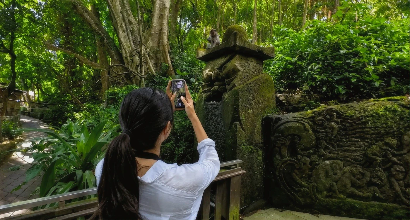 Isabel photographing wildlife while testing Fauna in a lush forest in Indonesia